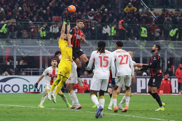 Milan, Italy, 8th January 2026. Nicola Leali of Genoa CFC leaps to claim the ball as he is challenged by Niklas Fullkrug of AC Milan during the AC Milan vs Genoa Serie A match at Giuseppe Meazza, Milan. Picture credit should read: Jonathan Moscrop Sportimage EDITORIAL USE ONLY. No use with unauthorised audio, video, data, fixture lists, club league logos or live services. Online in-match use limited to 120 images, no video emulation. No use in betting, games or single club league player publications. SPI_057_JM_MILAN_GENOA_ SPI-4409-0057
