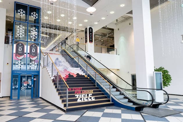 Eingangsbereich zum MTC Muenchen mit Rolltreppe und dem Schriftzug Am Start fuer grosse Ziele an der Treppe GER, DOSB Olympia-Einkleidung Team Deutschland, Mailand Cortina 2026, 09.01.2026. GER, DOSB Olympia-Einkleidung Team Deutschland, Mailand Cortina 2026, 09.01.2026. Muenchen *** Entrance area to the MTC Munich with escalator and the lettering At the start for big goals on the stairs GER, DOSB Olympic Dressing Team Germany, Milan Cortina 2026, 09 01 2026 GER, DOSB Olympic Dressing Team Germany, Milan Cortina 2026, 09 01 2026 Munich Copyright: xEibner-Pressefoto HeikexFeinerx EP_HFR