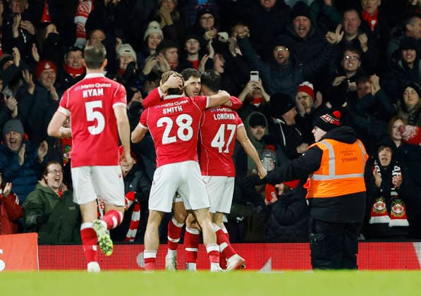 Wrexham, Wales, 9th January 2026. ILiberato Cacace of Wrexham is embraced after scoring the first goal during the Wrexham vs Nottingham Forest FA Cup third round match at the SToK Cae Ras, Wrexham. Picture credit should read: Cody Froggatt Sportimage EDITORIAL USE ONLY. No use with unauthorised audio, video, data, fixture lists, club league logos or live services. Online in-match use limited to 120 images, no video emulation. No use in betting, games or single club league player publications. SPI_045_CF_Wrexham_Forest SPI-4440-0048