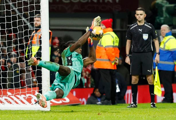 Wrexham, Wales, 9th January 2026. Arthur Okonkwo of Wrexham saves the penalty to send them through during the Wrexham vs Nottingham Forest FA Cup third round match at the SToK Cae Ras, Wrexham. Picture credit should read: Cody Froggatt Sportimage EDITORIAL USE ONLY. No use with unauthorised audio, video, data, fixture lists, club league logos or live services. Online in-match use limited to 120 images, no video emulation. No use in betting, games or single club league player publications. SPI_070_CF_Wrexham_Forest SPI-4440-0073