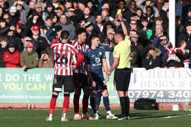 Cheltenham Town v Leicester City, FA Cup, 3rd Round Referee James Linington shows a yellow card to Leicester City defender Luke Thomas (33) & Cheltenham Town defender Jonathan Tomkinson (27) during the FA Cup match between Cheltenham Town and Leicester City at EV Charger Points Stadium, Cheltenham, UK on 10 January 2026. Cheltenham Jonny Rocks Stadium Gloucestershire UK Editorial use only DataCo restrictions apply See www.football-dataco.com , Copyright: xJohnxMallettx PSI-23561-0090