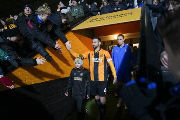 Dominic Ball of Cambridge United high fives the fans waiting above the tunnel as he leads his team out before the start of the match Cambridge United v Birmingham City, Emirates FA Cup, Third Round, Football, Cledara Abbey Stadium, Cambridge, UK - 10 Jan 2026Cambridge Cledara Abbey Stadium United Kingdom EDITORIAL USE ONLY No use with unauthorised audio, video, data, fixture lists, club league logos or live services. Online in-match use limited to 120 images, no video emulation. No use in betting, games or single club league player publications.  Copyright: xJedxLeicester Shutterstockx 16246307c