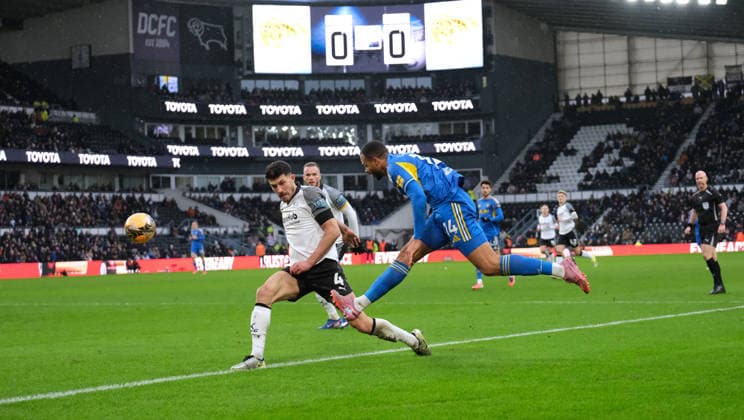 Lukas Nmecha of Leeds United crosses the ball under pressure from Danny Batth of Derby County during the Emirates FA Cup third round football match between Derby County and Leeds United at Pride Park Stadium in Derby. Copyright: xPaulxBonser SportsxPressxPhotox Sportspressphoto_SPR80777