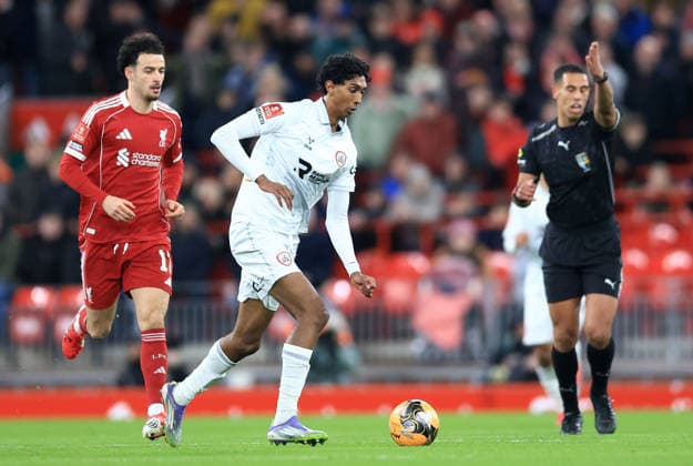 Liverpool, England, 12th January 2026. Vimal Yoganathan of Barnsley with the ball under pressure from Curtis Jones of Liverpool during the Liverpool vs Barnsley FA Cup match at Anfield, Liverpool. Picture credit should read: Jessica Hornby Sportimage EDITORIAL USE ONLY. No use with unauthorised audio, video, data, fixture lists, club league logos or live services. Online in-match use limited to 120 images, no video emulation. No use in betting, games or single club league player publications. SPI_041_JH_Liverpool_Barnsley SPI-4444-0041
