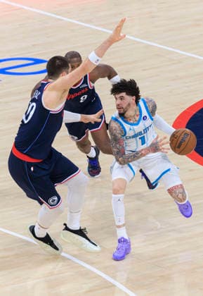 January 12, 2026, Inglewood, California, USA: Ivica Zubac 40 and Kris Dunn 8 of the Los Angeles Clippers guard LaMelo Ball 1 of the Charlotte Hornets during their regular season NBA, Basketball Herren, USA game on Monday January 12, 2026 at Intuit Dome in Inglewood, California. Clippers defeat Hornets, 117-109. ARIANA RUIZ PI Inglewood USA - ZUMAp124 20260112_zaa_p124_021 Copyright: xArianaxRuizx