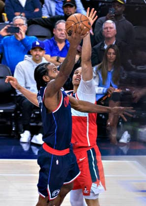 January 14, 2026, Inglewood, California, USA: Kawhi Leonard 2 of the Los Angeles Clippers drives past Kyshawn George 18 of the Washington Wizards for a layup during their 2025 NBA, Basketball Herren, USA regular season game on Wednesday January 14, 2026 at Intuit Dome Arena in Inglewood, California. JAVIER ROJAS PI Inglewood USA - ZUMAp124 20260114_zaa_p124_003 Copyright: xJavierxRojasx