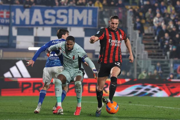 Como, Italy, 15th January 2026. Mike Maignan of AC Milan clashes with Maximo Perrone of Como 1907 as Adrien Rabiot of AC Milan clears the danger during the Como 1907 vs AC Milan Serie A match at Stadio Giuseppe Sinigaglia, Como. Picture credit should read: Jonathan Moscrop Sportimage EDITORIAL USE ONLY. No use with unauthorised audio, video, data, fixture lists, club league logos or live services. Online in-match use limited to 120 images, no video emulation. No use in betting, games or single club league player publications. SPI_091_JM_COMO_MILAN_ SPI-4414-0091