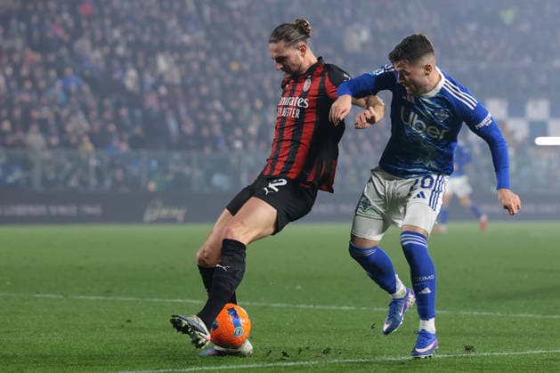 Como, Italy, 15th January 2026. Martin Baturina of Como 1907 tussles with Adrien Rabiot of AC Milan during the Como 1907 vs AC Milan Serie A match at Stadio Giuseppe Sinigaglia, Como. Picture credit should read: Jonathan Moscrop Sportimage EDITORIAL USE ONLY. No use with unauthorised audio, video, data, fixture lists, club league logos or live services. Online in-match use limited to 120 images, no video emulation. No use in betting, games or single club league player publications. SPI_097_JM_COMO_MILAN_ SPI-4414-0097