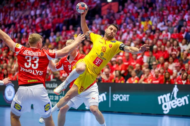 16 01 2026, Handball, Men s EHF EURO 2026, Denmark North Macedonia, Jyske Bank Boxen in Herning, Denmark, Preliminary Round Filip Kuzmanovski North Macedonia 18 vs Emil Siersbaek Bergholt Denmark 33 and Magnus Saugstrup Jensen Denmark 15 Denmark