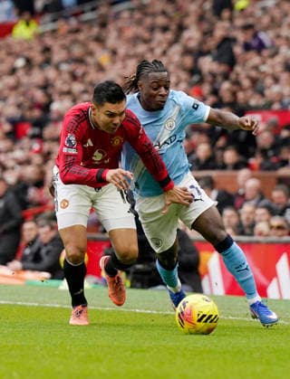 Manchester, England, 17th January 2026. Casemiro of Manchester United, ManU (l) tussles with Jeremy Doku of Manchester City (r) during the Manchester United vs Manchester City Premier League match at Old Trafford, Manchester. Picture credit should read: Andrew Yates Sportimage EDITORIAL USE ONLY. No use with unauthorised audio, video, data, fixture lists, club league logos or live services. Online in-match use limited to 120 images, no video emulation. No use in betting, games or single club league player publications. SPI_039_AY_ManUtd_ManCity SPI-4456-0038