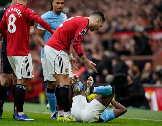 Manchester, England, 17th January 2026. Diogo Dalot of Manchester United, ManU questions Jeremy Doku of Manchester City after he went down under a tackle during the Manchester United vs Manchester City Premier League match at Old Trafford, Manchester. Picture credit should read: Andrew Yates Sportimage EDITORIAL USE ONLY. No use with unauthorised audio, video, data, fixture lists, club league logos or live services. Online in-match use limited to 120 images, no video emulation. No use in betting, games or single club league player publications. SPI_049_AY_ManUtd_ManCity SPI-4456-0047
