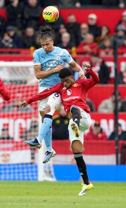 Manchester, England, 17th January 2026. Nathan Ake of Manchester City tussles with Amad Diallo of Manchester United, ManU during the Manchester United vs Manchester City Premier League match at Old Trafford, Manchester. Picture credit should read: Andrew Yates Sportimage EDITORIAL USE ONLY. No use with unauthorised audio, video, data, fixture lists, club league logos or live services. Online in-match use limited to 120 images, no video emulation. No use in betting, games or single club league player publications. SPI_059_AY_ManUtd_ManCity SPI-4456-0058