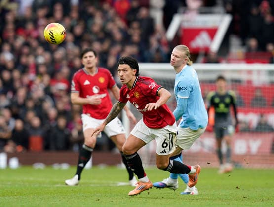 Manchester, England, 17th January 2026. Lisandro Martinez of Manchester United, ManU intercepts Erling Haaland of Manchester City during the Manchester United vs Manchester City Premier League match at Old Trafford, Manchester. Picture credit should read: Andrew Yates Sportimage EDITORIAL USE ONLY. No use with unauthorised audio, video, data, fixture lists, club league logos or live services. Online in-match use limited to 120 images, no video emulation. No use in betting, games or single club league player publications. SPI_087_AY_ManUtd_ManCity SPI-4456-0086