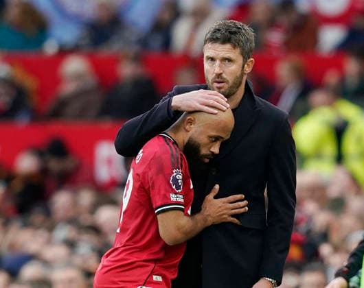 Manchester, England, 17th January 2026. Michael Carrick head coach of Manchester United, ManU hugs scorer Bryan Mbeumo of Manchester United as he replaces him during the Manchester United vs Manchester City Premier League match at Old Trafford, Manchester. Picture credit should read: Andrew Yates Sportimage EDITORIAL USE ONLY. No use with unauthorised audio, video, data, fixture lists, club league logos or live services. Online in-match use limited to 120 images, no video emulation. No use in betting, games or single club league player publications. SPI_096_AY_ManUtd_ManCity SPI-4456-0094