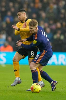 Wolverhampton, England, 18th January 2026. Joao Gomes of Wolverhampton Wanderers tussles with Lewis Hall during the Wolverhampton Wanderers vs Newcastle United Premier League match at Molineux, Wolverhampton. Picture credit should read: Andrew Yates Sportimage EDITORIAL USE ONLY. No use with unauthorised audio, video, data, fixture lists, club league logos or live services. Online in-match use limited to 120 images, no video emulation. No use in betting, games or single club league player publications. SPI_049_AY_Wolves_Newcastle SPI-4461-0048