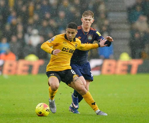 Wolverhampton, England, 18th January 2026. Joao Gomes of Wolverhampton Wanderers and Lewis Hall of Newcastle United during the Wolverhampton Wanderers vs Newcastle United Premier League match at Molineux, Wolverhampton. Picture credit should read: Andrew Yates Sportimage EDITORIAL USE ONLY. No use with unauthorised audio, video, data, fixture lists, club league logos or live services. Online in-match use limited to 120 images, no video emulation. No use in betting, games or single club league player publications. SPI_056_AY_Wolves_Newcastle SPI-4461-0055