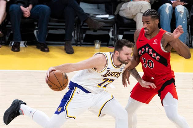 January 18, 2026, Los Angeles, California, USA: Los Angeles LakersÃ¢â‚¬â ¢ Luka DonÄÂiÄ¡ (77) drives against Toronto Raptors Ochai Agbaji (30) during an NBA, Basketball Herren, USA basketball game at Crypto.com Arena on Sunday, Jan. 18, 2026 in Los Angeles. Los Angeles USA - ZUMAc68_ 20260118_zaf_c68_047 Copyright: xRingoxChiux