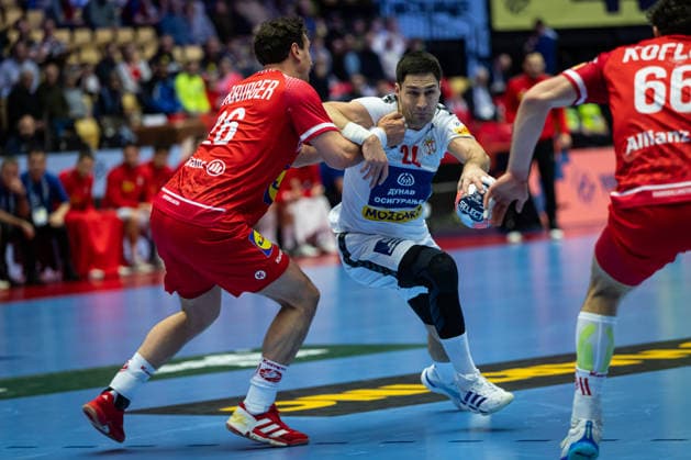 HERNING, DENMARK - JANUARY 19: Lazar Kukic (Serbia, 24) against Lukas Herburger (Austria, 26) during the EHF EURO 2026 match between Austria vs Serbia at Jyske Bank Boxen Arena on matchday 3 of the Group Matches Group A on January 19, 2026 in Herning, Denmark. Midtjylland Denmark Copyright: xMarioxM.xKobergx