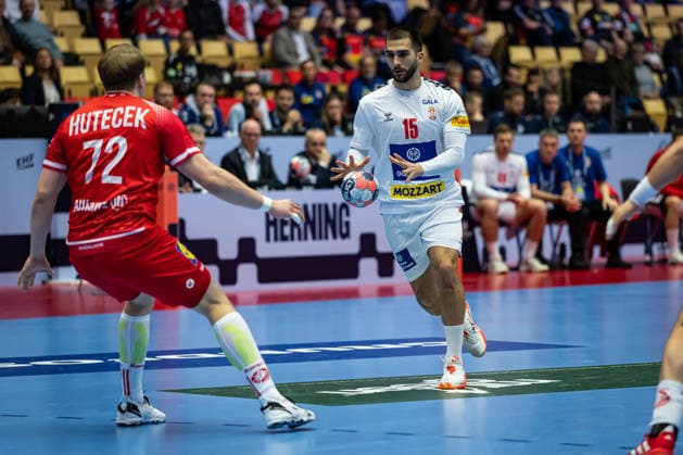 HERNING, DENMARK - JANUARY 19: Uros Kojadinovic (Serbia, 15) against Lukas Hutecek (Austria, 72) during the EHF EURO 2026 match between Austria vs Serbia at Jyske Bank Boxen Arena on matchday 3 of the Group Matches Group A on January 19, 2026 in Herning, Denmark. Midtjylland Denmark Copyright: xMarioxM.xKobergx
