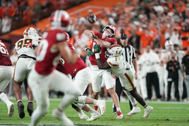 MIAMI GARDENS, FL - JANUARY 19: QB Fernando Mendoza 15 of the Indiana Hoosiers gets hit as he throws in the first half during the Indiana Hoosiers versus the Miami Hurricanes College Football Playoff National Championship Game Presented by AT&T on January 19, 2026, at Hard Rock Stadium in Miami Gardens, FL. (Photo by Peter Joneleit Icon Sportswire) COLLEGE FOOTBALL: JAN 19 College Football Playoff National Championship Presented by AT&T Indiana vs Miami EDITORIAL USE ONLY Icon260119060