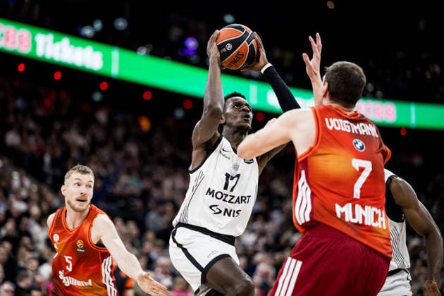 MUNICH, GERMANY - JANUARY 20: Isaac Bonga (Partizan Mozzart Bet Belgrade, 17) controls the ball against Johannes Voigtmann (FC Bayern Muenchen, 7) during the Turkish Airlines EuroLeague match between FC Bayern Muenchen vs. Partizan Mozzart Bet Belgrade at SAP Garden on round 23 of Turkish Airlines EuroLeague on January 20, 2026 in Munich, Germany. Bavaria Germany Copyright: xSteffiexWunderlx