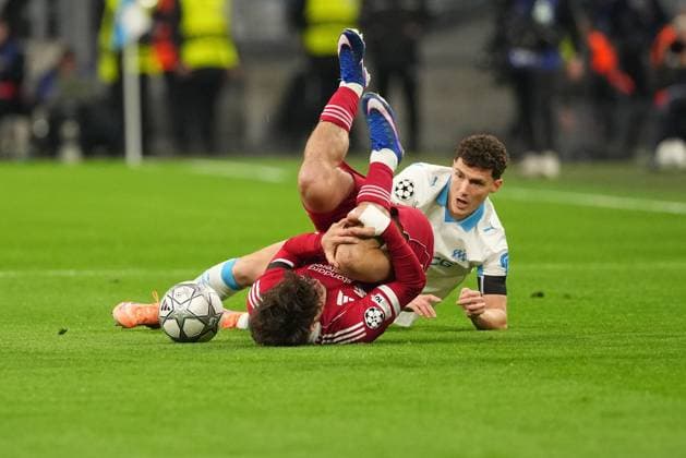 Milos Kerkez of Liverpool is tackled by Benjamin Pavard of Marseille Marseille v Liverpool, UEFA Champions League, Group Stage, Football, Orange Velodrome, Marseille, France - 21 Jan 2026Marseille Orange Vélodrome France EDITORIAL USE ONLY No use with unauthorised audio, video, data, fixture lists, club league logos or live services. Online in-match use limited to 120 images, no video emulation. No use in betting, games or single club league player publications. Copyright: xDavexWinter Shutterstockx 16348361ao