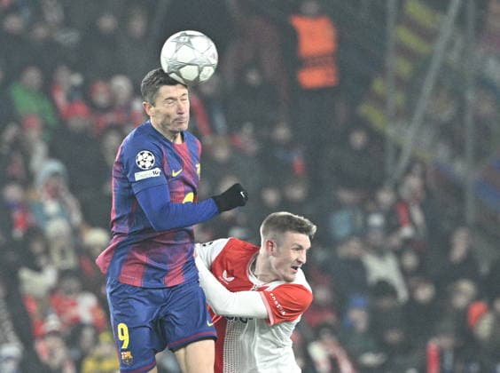 Robert Lewandowski of Barcelona, left, and Stepan Chaloupek of Slavia in action during the Champions League 7th round match Slavia Praha vs FC Barcelona, Barca in Pilsen, Czech Republic, January 21, 2026. (CTKxPhoto MichalxKrumphanzl) CTKPhotoP2026012110835  CTKPhotoP2026012110835