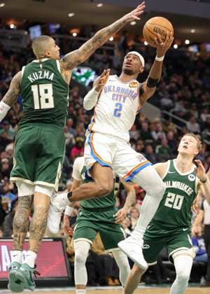 (260122) -- MILWAUKEE, Jan. 22, 2026 -- Oklahoma City Thunder s Shai Gilgeous-Alexander (top R) drives to the basket during the 2025-2026 NBA, Basketball Herren, USA regular season game between Milwaukee Bucks and Oklahoma City Thunder in Milwaukee, the United States, Jan. 21, 2026. (Photo by Xinhua) (SP)U.S.-MILWAUKEE-BASKETBALL-NBA-BUCKS VS THUNDER JoelxLerner 