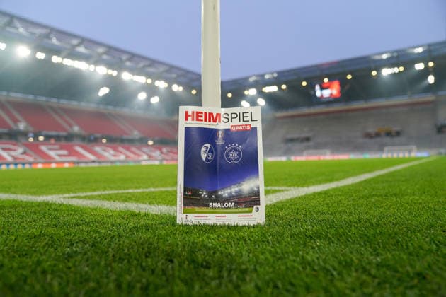 Football UEFA Europa League 2025 26, Matchday 7 SC Freiburg vs Maccabi Tel Aviv Europa Park Stadion Freiburg The stadium magazine Heimspiel with club logos and UEFA Europa League branding stands on the sidelines on the pitch Evening match, floodlights, empty stadium before kick-off, international match, security, organization, match preparation, soccer, UEFA, Europa League, SC Freiburg, Maccabi Tel Aviv, Freiburg Copyright: xJOERANxSTEINSIEKx