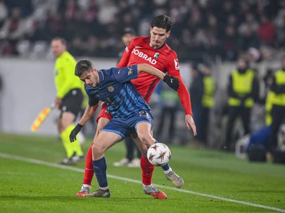Noam Ben Harosh Maccabi Tel Aviv FC and Igor MatanoviÄ‡ SC Freiburg battle for the ball during the UEFA Europa League 2025 26 League Phase MD7 match between SC Freiburg and Maccabi Tel Aviv FC at Stadion am Wolfswinkel on January 22, 2026 in Freiburg im Breisgau, Germany Photo by Harry Langer DeFodi Images