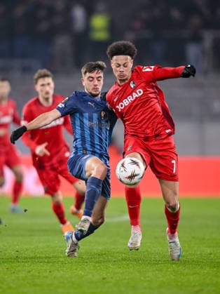 Noam Ben Harosh Maccabi Tel Aviv FC and Derry Scherhant SC Freiburg battle for the ball during the UEFA Europa League 2025 26 League Phase MD7 match between SC Freiburg and Maccabi Tel Aviv FC at Stadion am Wolfswinkel on January 22, 2026 in Freiburg im Breisgau, Germany Photo by Harry Langer DeFodi Images