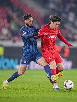 Sagiv Jehezkel Maccabi Tel Aviv FC and Yuito Suzuki SC Freiburg battle for the ball during the UEFA Europa League 2025 26 League Phase MD7 match between SC Freiburg and Maccabi Tel Aviv FC at Stadion am Wolfswinkel on January 22, 2026 in Freiburg im Breisgau, Germany Photo by Harry Langer DeFodi Images