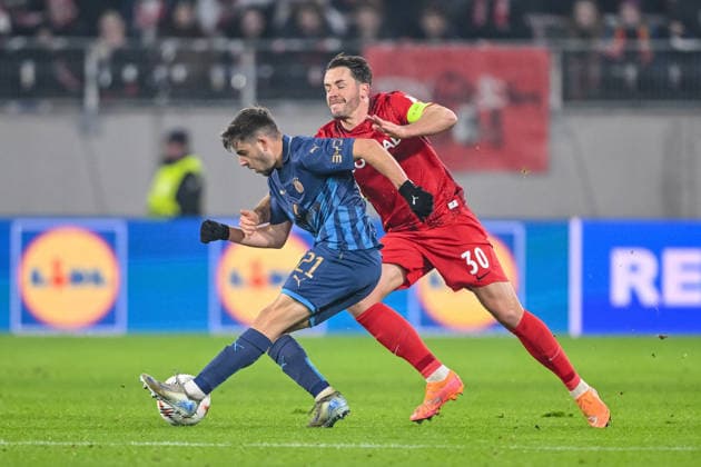 Noam Ben Harosh Maccabi Tel Aviv FC and Christian Günter SC Freiburg battle for the ball during the UEFA Europa League 2025 26 League Phase MD7 match between SC Freiburg and Maccabi Tel Aviv FC at Stadion am Wolfswinkel on January 22, 2026 in Freiburg im Breisgau, Germany Photo by Harry Langer DeFodi Images