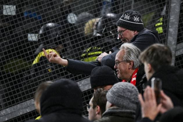 A football fan gives the middle finger to police ahead of a soccer game between Dutch soccer club FC Utrecht and Belgian KRC Genk, on Thursday 22 January 2026 in Utrecht, Netherlands, the seventh game (out of 8) in the league phase of the UEFA Europa League competition. TOM GOYVAERTS TomxGoyvaerts  x157802393x
