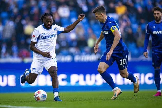Marvin Wanitzek 10 Karlsruher SC in duel with Deyovaisio Zeefuik 42 Hertha BSC while Fabian Schleusener 24 Karlsruher SC attentively follows duel for the ball Copyright: xspeedshotx