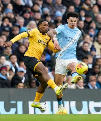 Manchester, England, 24th January 2026. Jackson Tchatchoua of Wolverhampton Wanderers (L) challenges Nico O™Reilly of Manchester City during the Manchester City vs Wolverhampton Wanderers Premier League match at the Etihad Stadium, Manchester. Picture credit should read: Andrew Yates Sportimage EDITORIAL USE ONLY. No use with unauthorised audio, video, data, fixture lists, club league logos or live services. Online in-match use limited to 120 images, no video emulation. No use in betting, games or single club league player publications. SPI_012_AY_MAN_CITY_WOLVES SPI-4473-0012