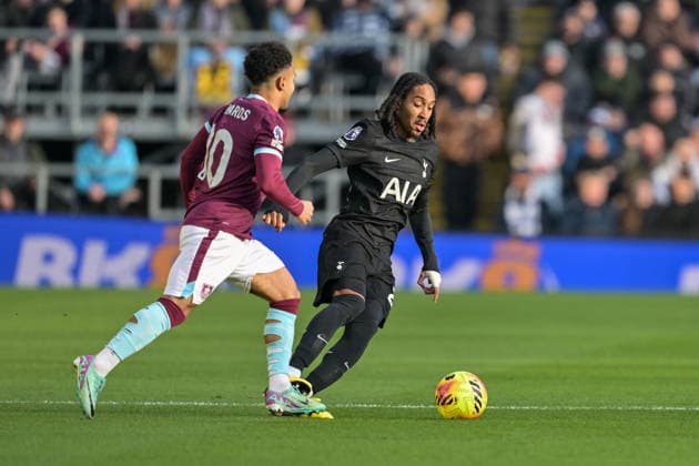 24th January 2026; Turf Moor, Burnley, Lancashire, England; Premier League Football, Burnley versus Tottenham Hotspur; Djed Spence of Tottenham Hotspur controls the ball while pressured from Marcus Edwards of Burnley  LeexDurkin Content restricted for UK based newspaper