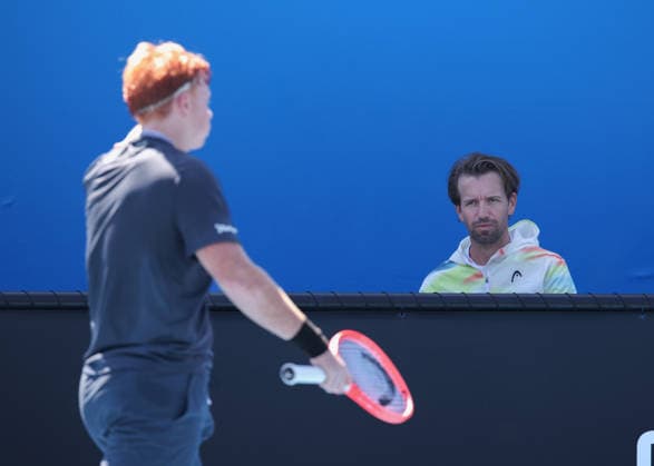 Jamie Mackenzie GER blurred in the foreground, Trainer,coach Gero Kretschmer, Boys Singles, Boys Singles,Australian Open 2026, Melbourne Park, Melbourne, Victoria, Australia , Copyright: xJuergenxHasenkopfx