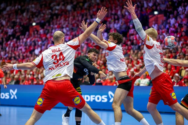 26 01 2026, Handball, Men s EHF EURO 2026, Germany Denmark, Jyske Bank Boxing in Herning, Denmark, Main Round Marko Grgic Germany 71 in a duel against Simon Hald Jensen Denmark 34 Niclas Vest Kirkelokke Denmark 03 Underpants visible because his pants are being pulled and Magnus Saugstrup Jensen Denmark 15 Denmark