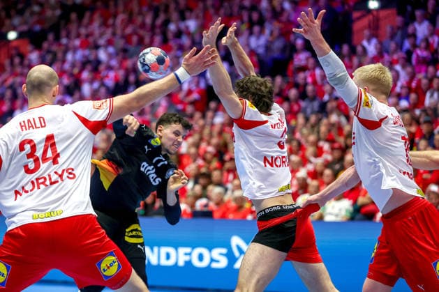 26 01 2026, Handball, Men s EHF EURO 2026, Germany Denmark, Jyske Bank Boxen in Herning, Denmark, Main Round Magnus Saugstrup Jensen Denmark 15 r pulls Niclas Vest Kirkelokke Denmark 03 by the pants next to Simon Hald Jensen Denmark 34 Marko Grgic Germany 71 throws the ball at the goal Denmark