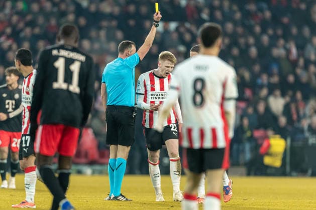 Referee Joao Pinheiro shows Jerdy Schouten PSV Eindhoven the yellow card during the UEFA Champions League 2025 26 League Phase MD8 match between PSV Eindhoven and FC Bayern München at PSV Stadion on January 28, 2026 in Eindhoven, Netherlands