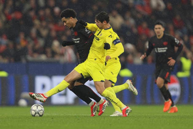 Malik Tillmann Bayer 04 Leverkusen and Santi Comesana Villarreal CF battle for the ball during the UEFA Champions League 2025 26 League Phase MD8 match between Bayer 04 Leverkusen and Villarreal CF at BayArena on January 28, 2026 in Leverkusen, Germany Photo by Oliver Kaelke DeFodi Images