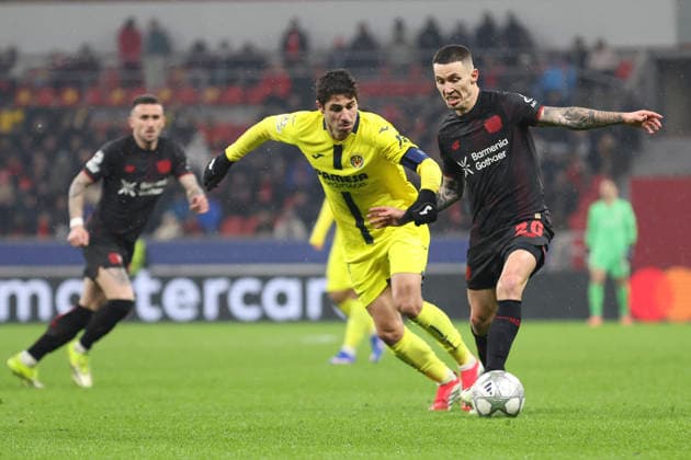 Santi Comesana Villarreal CF and Alejandro Grimaldo Bayer 04 Leverkusen battle for the ball during the UEFA Champions League 2025 26 League Phase MD8 match between Bayer 04 Leverkusen and Villarreal CF at BayArena on January 28, 2026 in Leverkusen, Germany Photo by Oliver Kaelke DeFodi Images