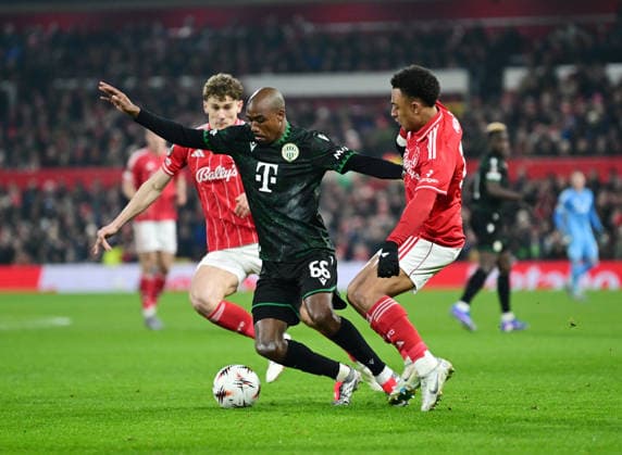 Nottingham, England, 29th January 2026. Julio Romao of Ferencvaros (c) tackled by Ryan Yates of Nottingham Forest (l) and Dan Ndoye of Nottingham Forest (r) and nf during the Nottingham Forest vs Ferencvaros UEFA Europa League match at the City Ground, Nottingham. Picture credit should read: Harriet Massey Sportimage EDITORIAL USE ONLY. No use with unauthorised audio, video, data, fixture lists, club league logos or live services. Online in-match use limited to 120 images, no video emulation. No use in betting, games or single club league player publications. SPI_032_HM_Forest_Ferencvaros SPI-4491-0031