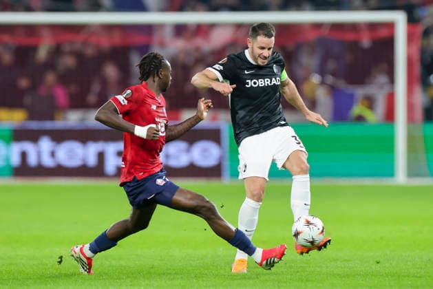 Ngal Ayel Mukau OSC Lille and Christian Guenter SC Freiburg battle for the ball, UEFA Europa League 2025 26 League Phase MD8, LOSC Lille v SC Freiburg, Stade Pierre Mauroy on January 29, 2026 in Lille, France Photo by Marco Steinbrenner DeFodi Images Ngal Ayel Mukau OSC Lille and Christian Guenter SC Freiburg battle for the ball, UEFA Europa League 2025 26 League Phase MD8, LOSC Lille v SC Freiburg, Stade Pierre Mauroy, January 29, 2026 in Lille, France Photo by Marco Steinbrenner DeFodi Images