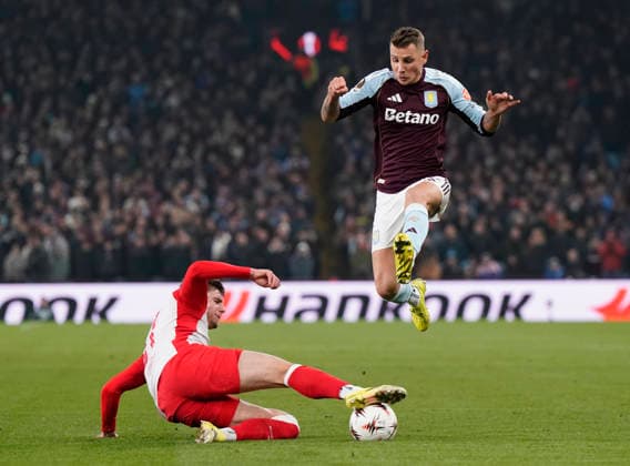 Birmingham, England, 29th January 2026. Lucas Digne of Aston Villa jumps over Tim Trummer of Red Bull Salzburg during the Aston Villa vs FC Salzburg UEFA Europa League match at Villa Park, Birmingham. Picture credit should read: Andrew Yates Sportimage EDITORIAL USE ONLY. No use with unauthorised audio, video, data, fixture lists, club league logos or live services. Online in-match use limited to 120 images, no video emulation. No use in betting, games or single club league player publications. SPI_038_AY_Villa_Salzburg SPI-4490-0037