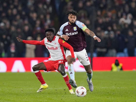 Birmingham, England, 29th January 2026. Edmund Baidoo of Red Bull Salzburg tussles with Tyrone Mings of Aston Villa during the Aston Villa vs FC Salzburg UEFA Europa League match at Villa Park, Birmingham. Picture credit should read: Andrew Yates Sportimage EDITORIAL USE ONLY. No use with unauthorised audio, video, data, fixture lists, club league logos or live services. Online in-match use limited to 120 images, no video emulation. No use in betting, games or single club league player publications. SPI_043_AY_Villa_Salzburg SPI-4490-0042