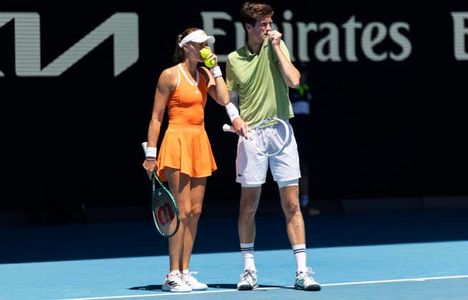 (260130) -- MELBOURNE, Jan. 30, 2026 -- Kristina Mladenovic (L) Manuel Guinard communicate during the mixed doubles final match between Olivia Gadecki John Peers of Australia and Kristina Mladenovic Manuel Guinard of France at the Australian Open tennis tournament in Melbourne, Australia, Jan. 30, 2026. (Photo by Xinhua) (SP)AUSTRALIA-MELBOURNE-TENNIS-AUSTRALIAN OPEN-MIXED DOUBLES-FINAL HuxJingchen 