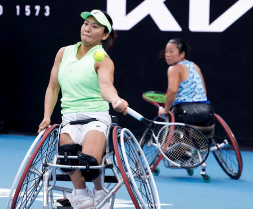 (260130) -- MELBOURNE, Jan. 30, 2026 -- Zhu Zhenzhen (L) Kamiji Yui compete during the women s wheelchair doubles final between Wang Ziying Li Xiaohui (China) and Zhu Zhenzhen (China) Kamiji Yui (Japan) at the Australian Open tennis tournament in Melbourne, Australia, Jan. 30, 2026. ) (SP)AUSTRALIA-MELBOURNE-TENNIS-AUSTRALIAN OPEN-WOMEN S WHEELCHAIR DOUBLES-FINAL MaxPing 