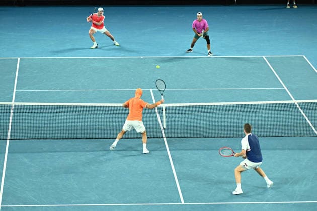 TENNIS AUSTRALIAN OPEN, Jason Kubler (pink) and Marc Polmans (red) of Australia (top) in action during the men™s doubles final against Christian Harrison of the USA and Neal Skupski of Great Britian on day 14 of the 2026 Australian Open tennis tournament at Melbourne Park in Melbourne, Saturday, January 31, 2026. ( NO ARCHIVING MELBOURNE VICTORIA AUSTRALIA  Copyright: xJOELxCARRETTx 20260131160062764426